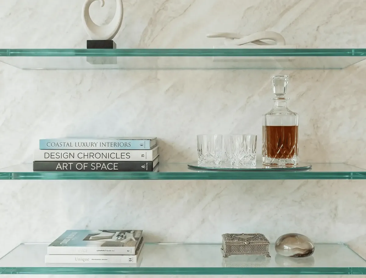 Heavy-duty custom glass shelves displaying luxury bathroom amenities and decor