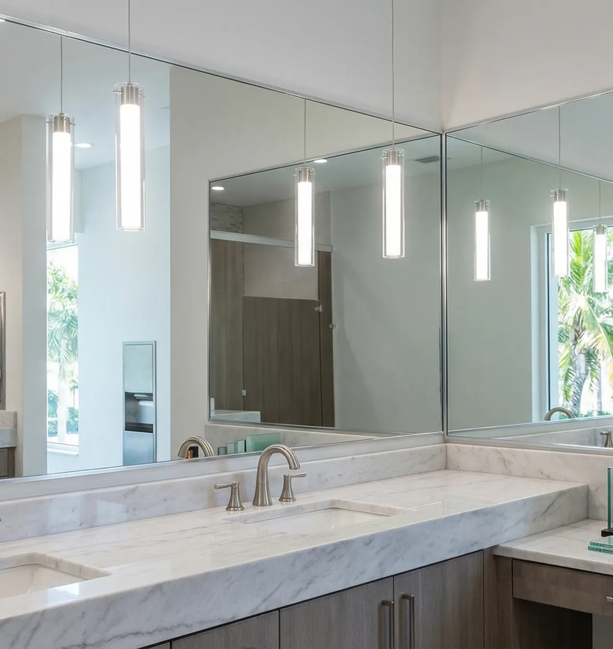 High-end public bathroom mirrors installed in a Naples commercial space with elegant lighting