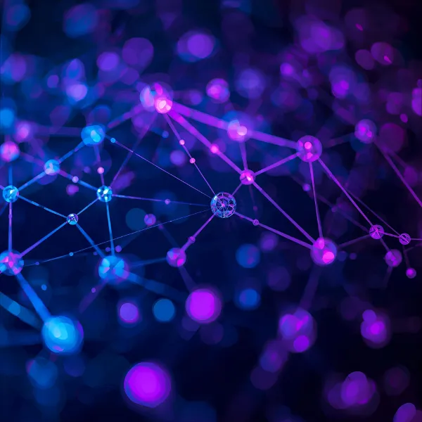 Abstract digital network made of glowing blue and purple nodes connected by thin lines, creating a web-like structure against a dark blurred background.