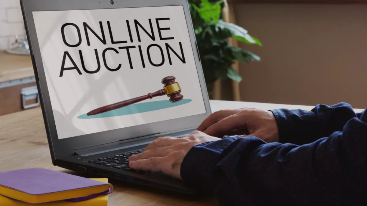 Open computer with "Online Auction" on the screen