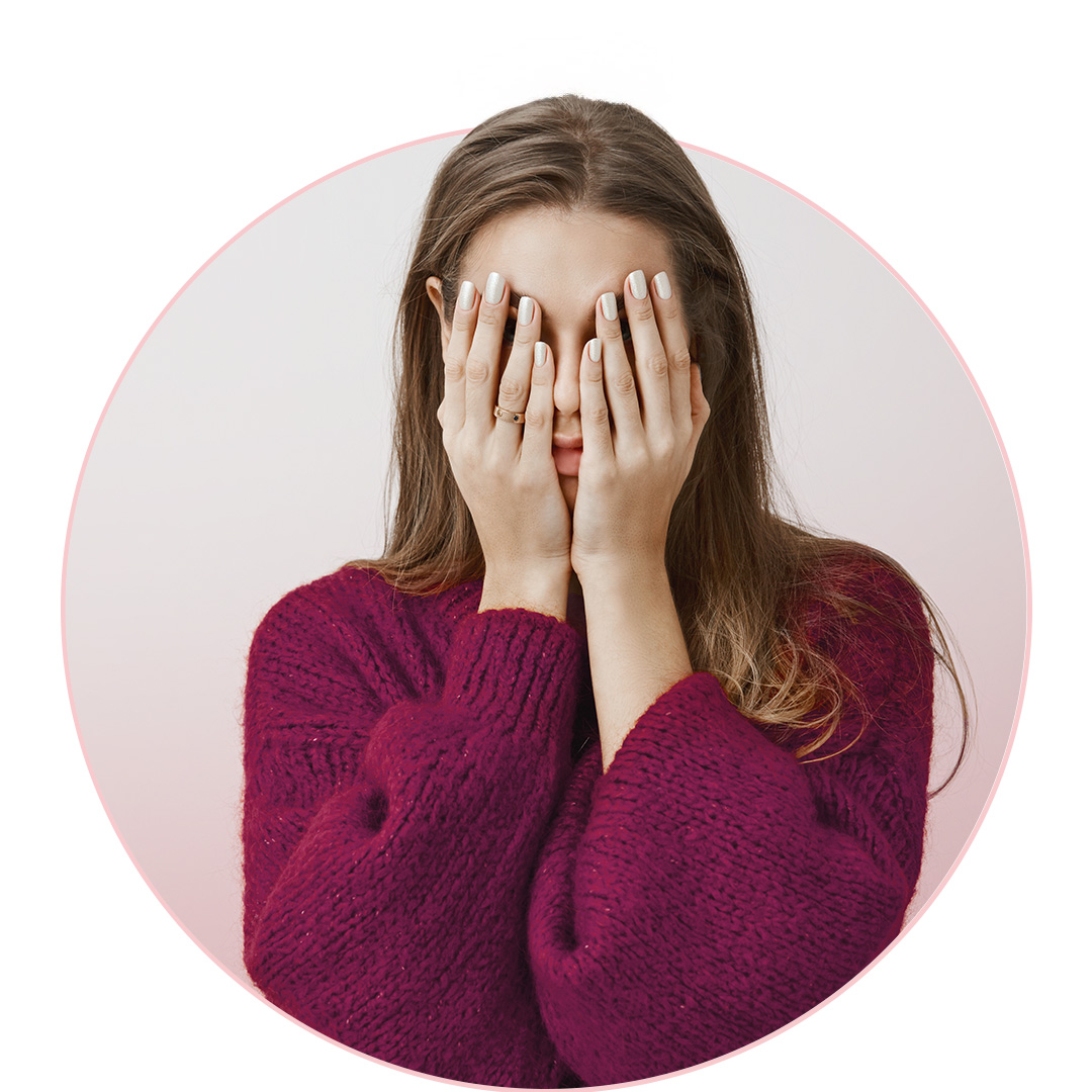 woman with hands covering face
