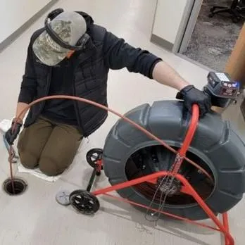 Man using hydro jetting in a pipe