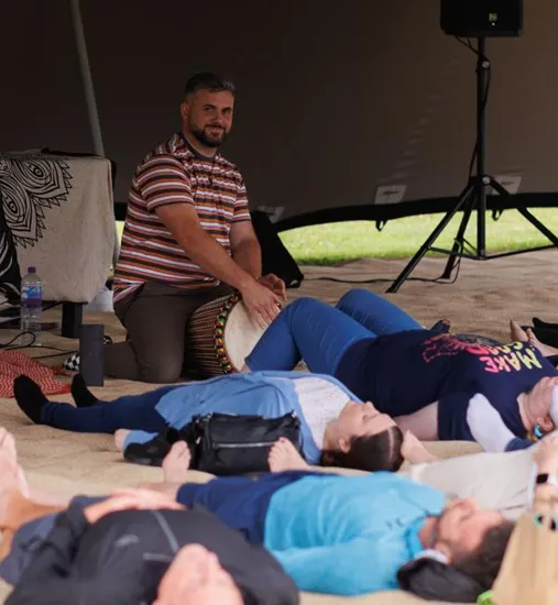 Paul McAllister leading drumming circle at retreat
