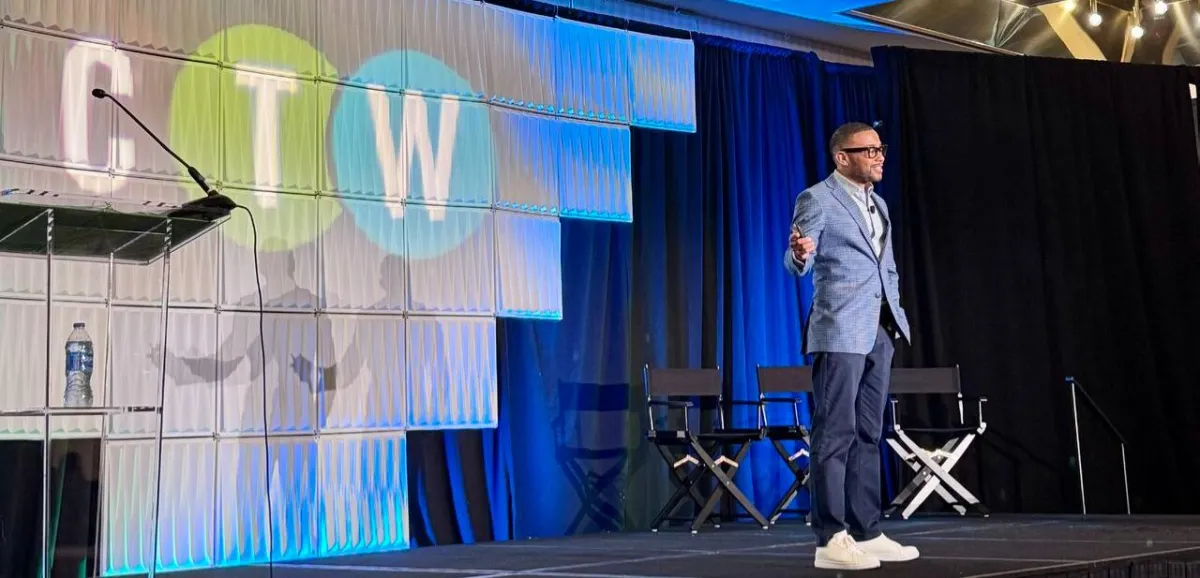 Ethan King on stage delivering an AI keynote to a business audience