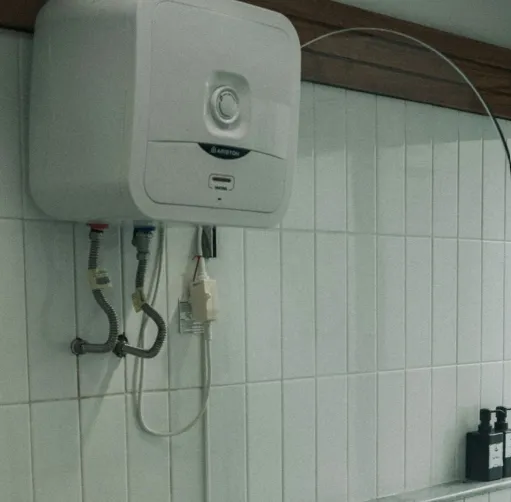 Plumber installing modern water heater unit