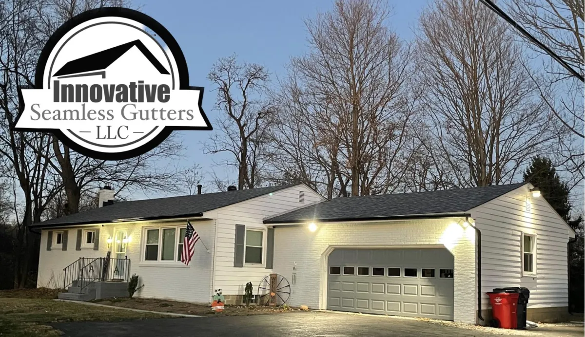 Image of small family home with new gutters installed and an American flag out front