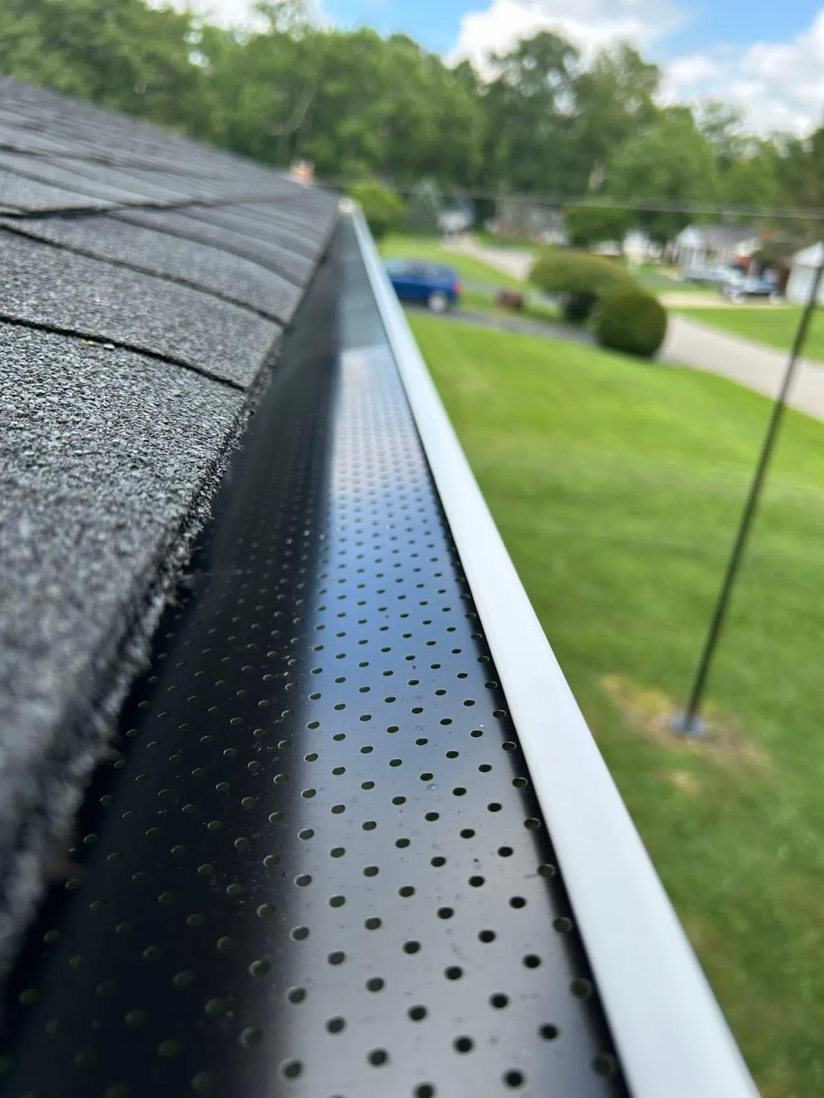 new gutters installed on large red pole barn