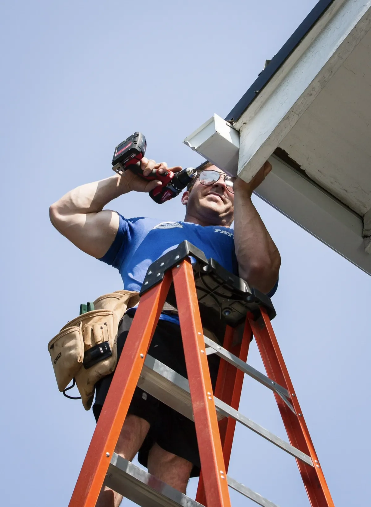 Image of man cleaning gutters by hand