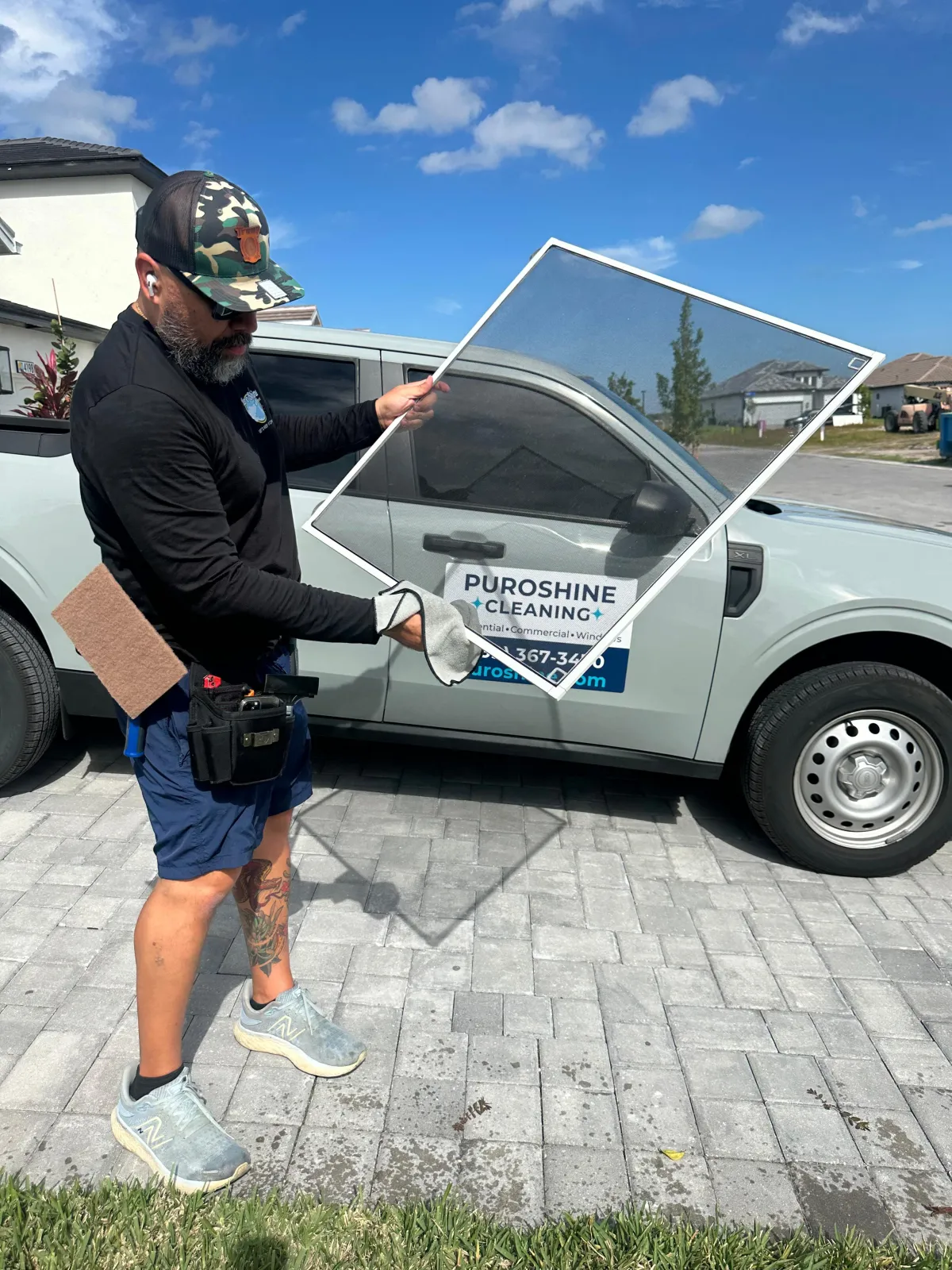 Puroshine team member cleaning a window screen in Skysail Naples
