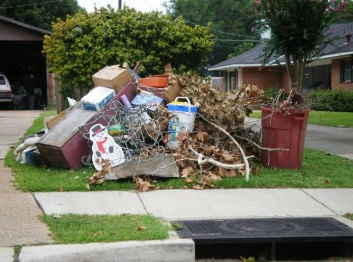 A big lump of yard waste - twigs, leaves on the grass of outside yard