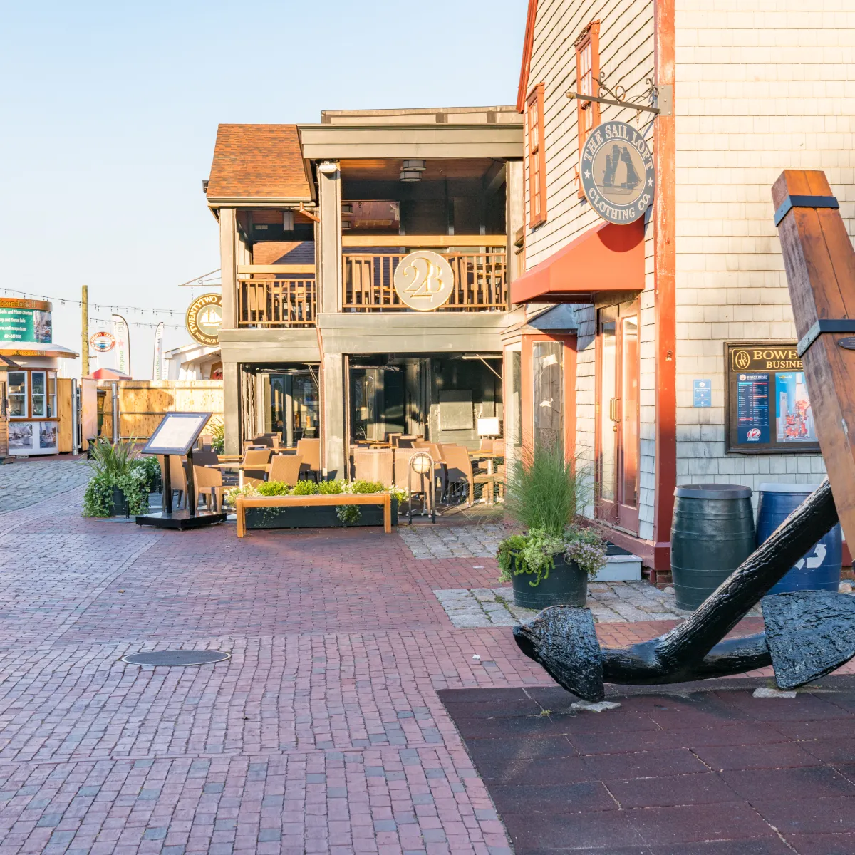 Shops and nautical-themed decor on Bowen's Wharf in Newport, Rhode Island, capturing the charm of the local small business district.
