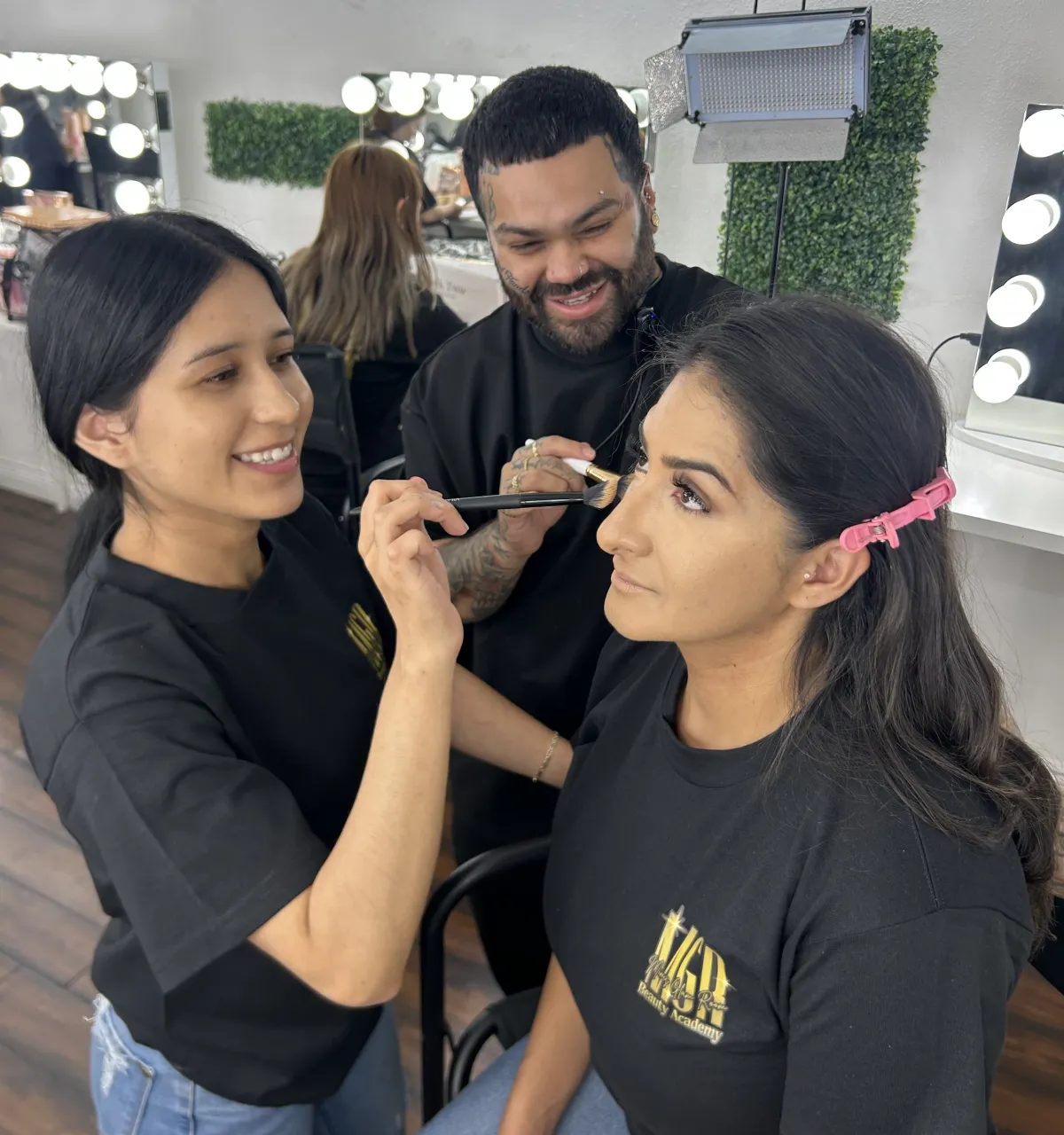 Three beauty creators celebrating in a bright salon environment