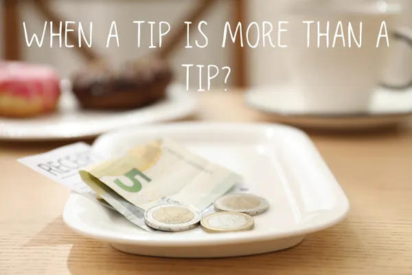 Tip money on a dish on a table