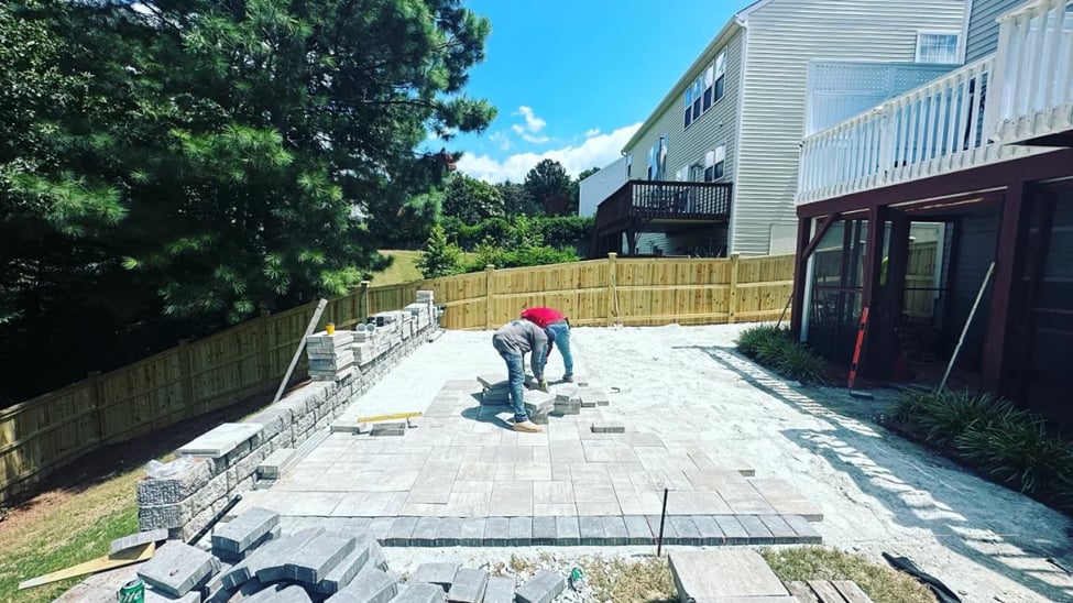 Paver patio installation in progress by a professional  hardscaping contractor in Durham, NC