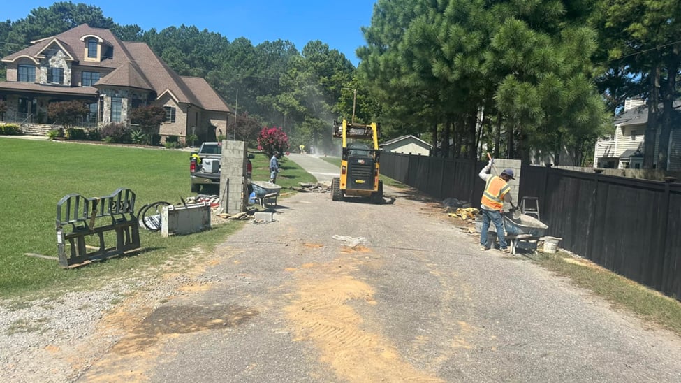 Professional concrete contractor in Durham NC working on  a driveway demolition with heavy equipment on job site