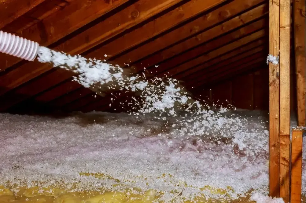 Blown-in attic insulation using fiberglass in Panama City FL by Blue Line Insulation