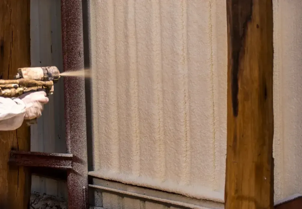 Applying intumescent fire-resistant coating to metal wall in Panama City FL by Blue Line Insulation