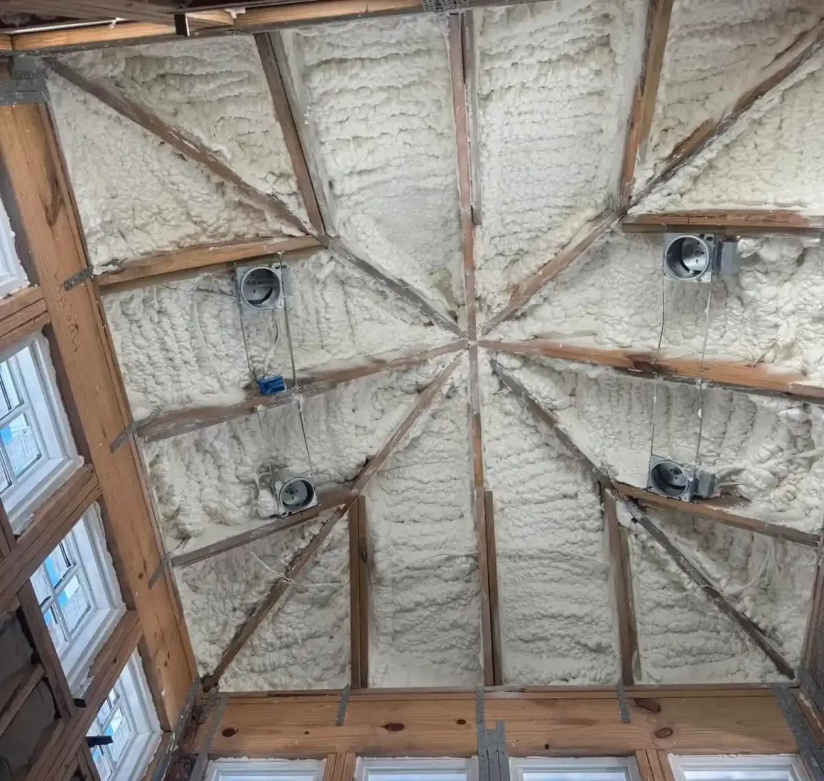 Open cell spray foam applied to ceiling rafters in a Panama City home for improved energy efficiency noise reduction and year round comfort