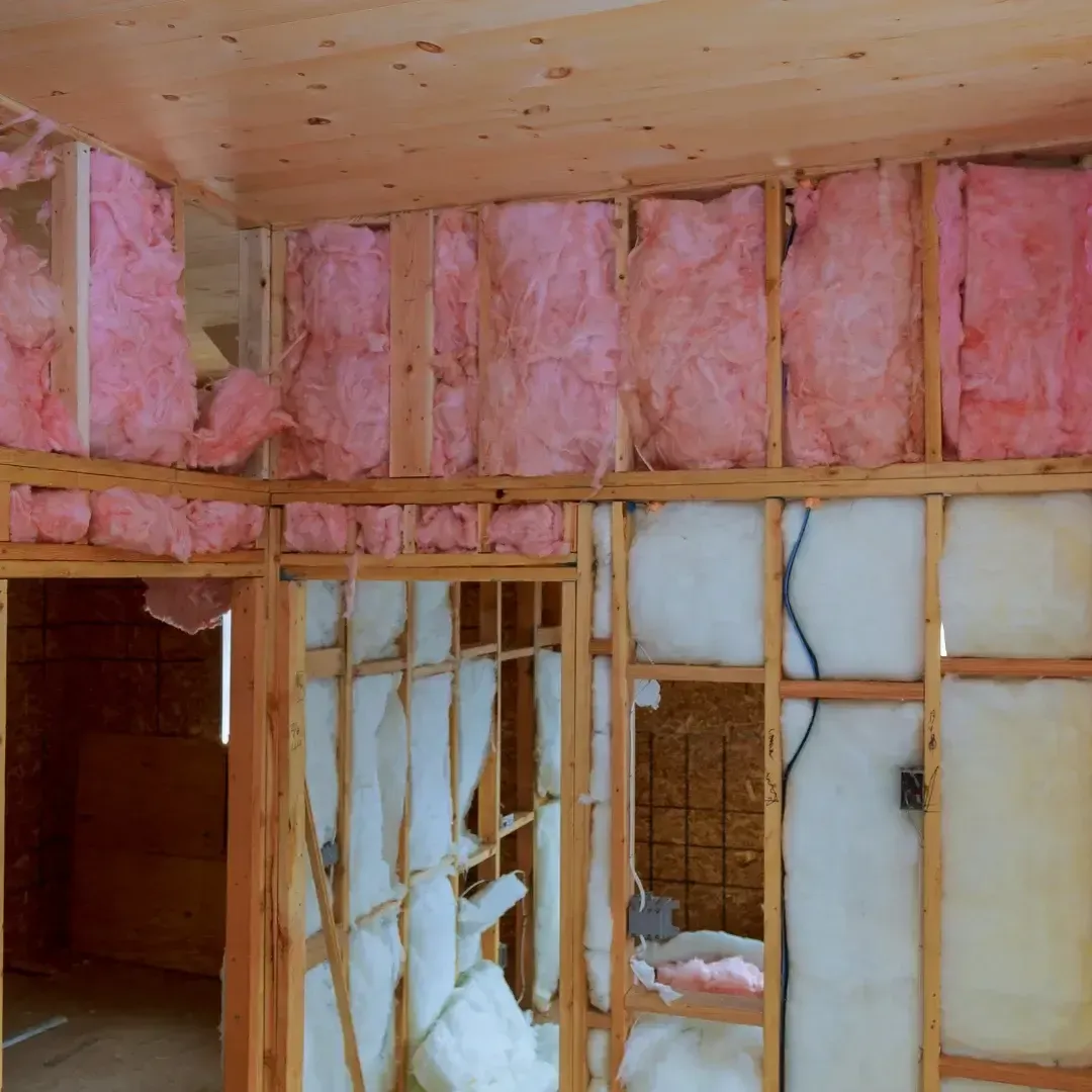 Fiberglass batt insulation installed in wall and ceiling cavities in Rosemary FL by Blue Line Insulation