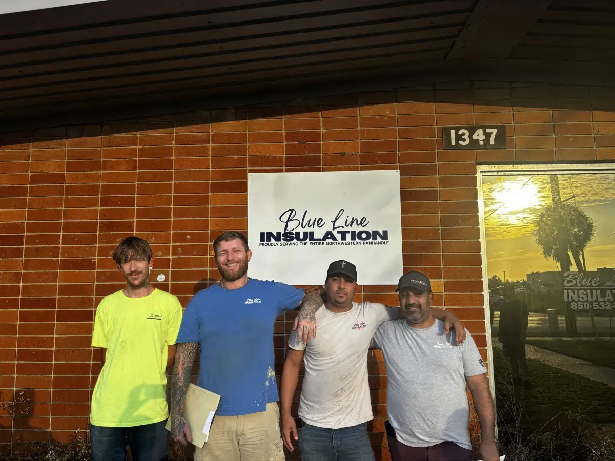 Blue Line Insulation team standing outside the company building, representing their family-owned insulation services