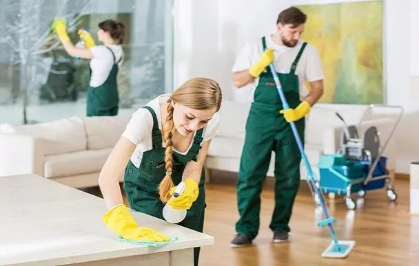 Young girl vacuuming a striped rug in a living room.