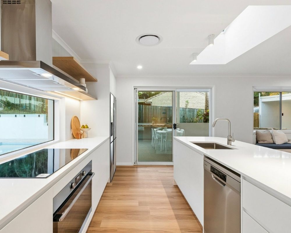 Contemporary white kitchen with large island bench