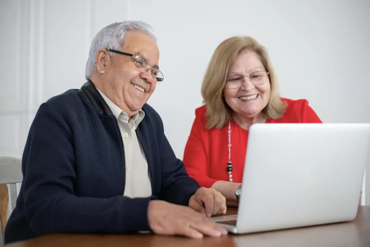 Happy couple looking at computer