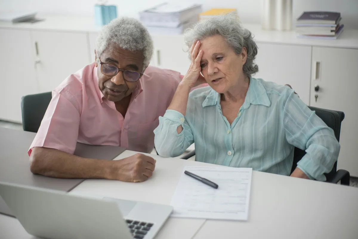 Frustrated couple looking at computer