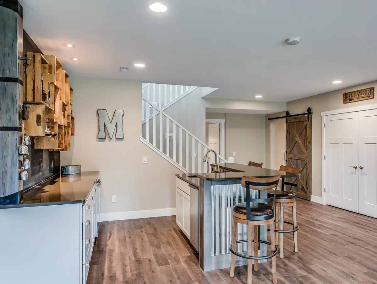 Open concept home renovation with updated staircase, wood flooring, and modern living space by Dream Design Building Group Jacksonville