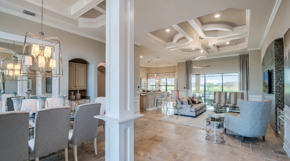 Home addition interior with open concept living and dining area, coffered ceilings, and elegant finishes by Dream Design Building Group Jacksonville