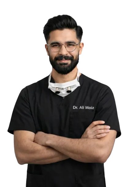 Lead dental surgeon at Lahore Dental Studio smiling warmly in clinical scrubs