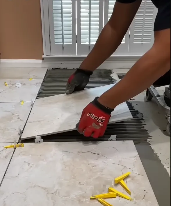 contractor laying white tiles on 