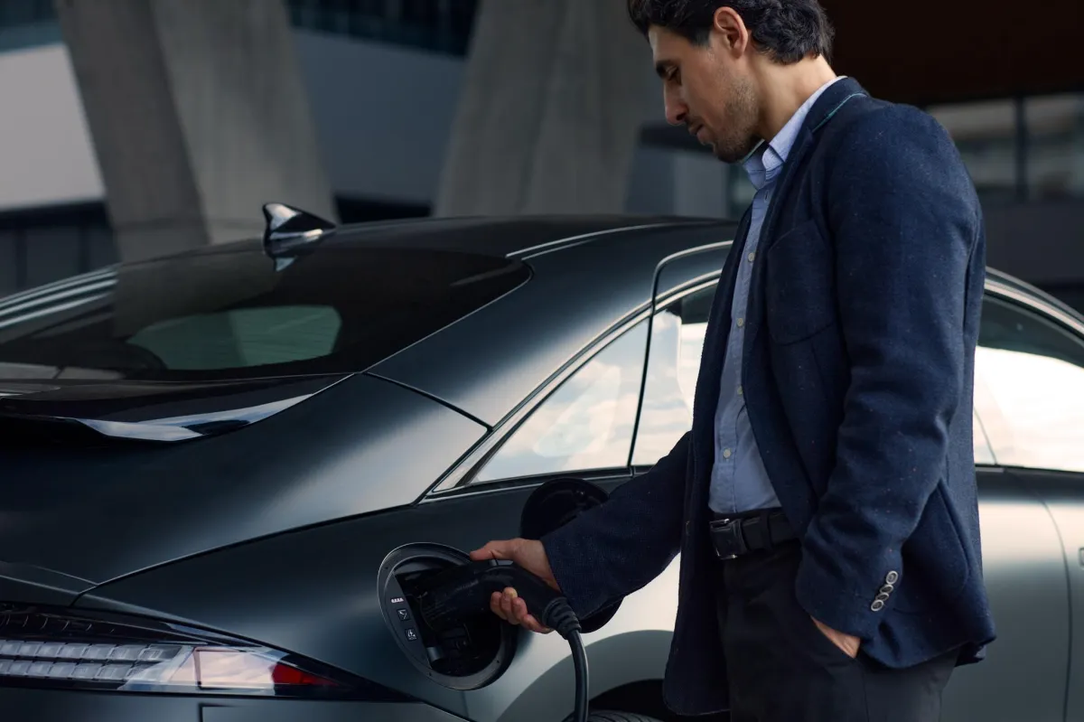 A man charging an electric car