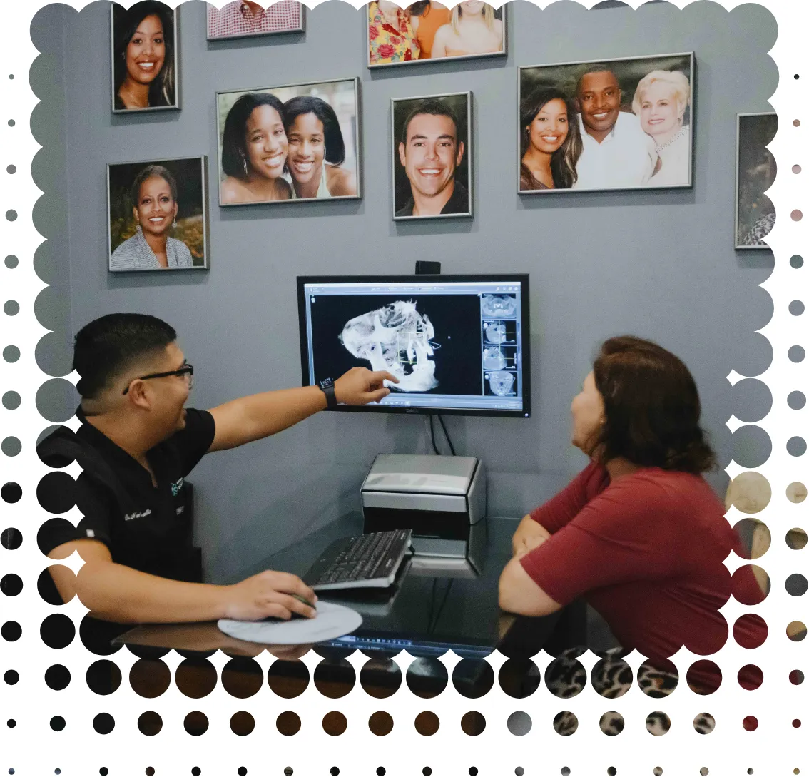 Woman smiling looking at tablet with dental implants