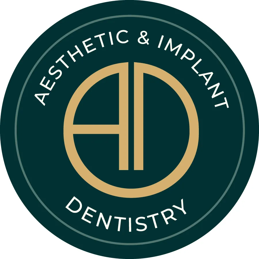 Aesthetic & Implant Dentistry Logo