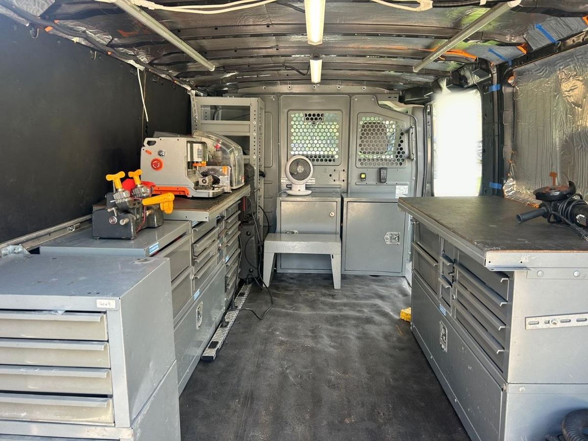 Inside the American Locksmith Services van: steel drawer cabinets, workbenches and key-cutting machines