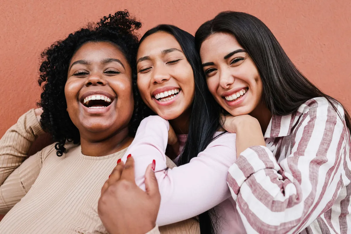 Three women laughing together