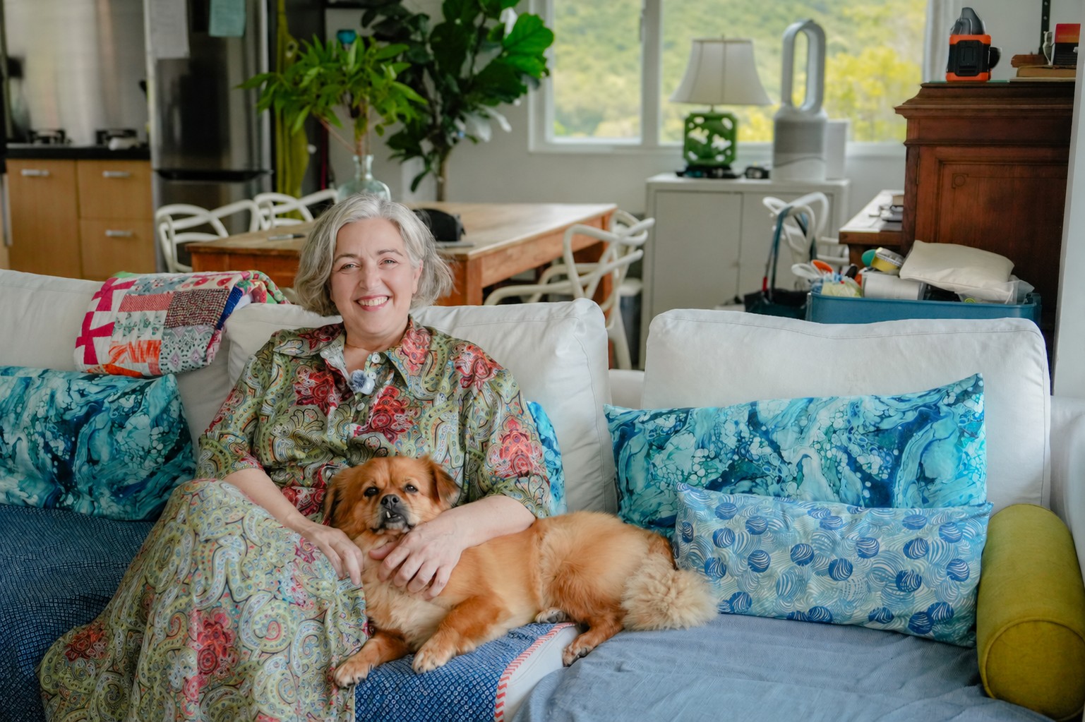 Josianne at home in Hong Kong, with her rescued Tibetan Spaniel Bayo, one of three dogs