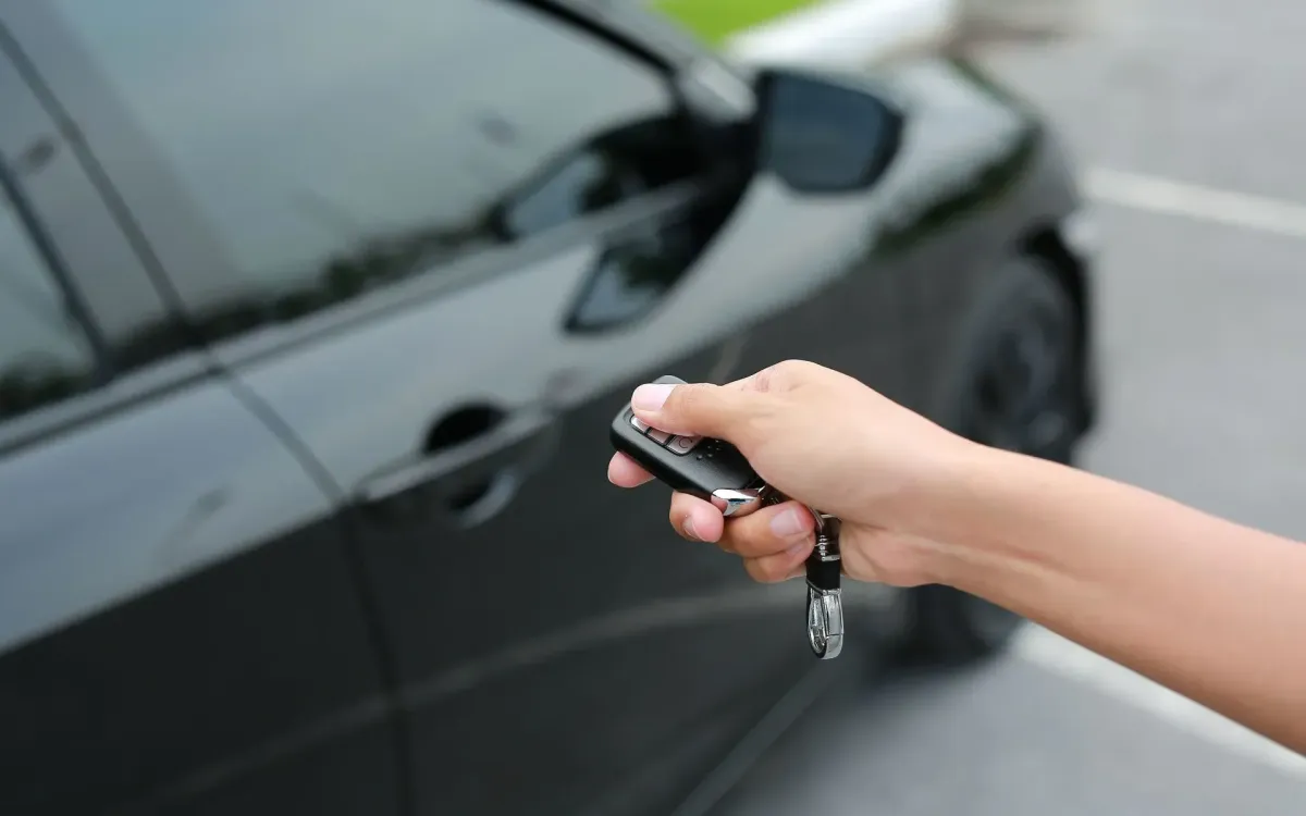 a hand holding a remote starter