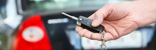 a hand holding a car key