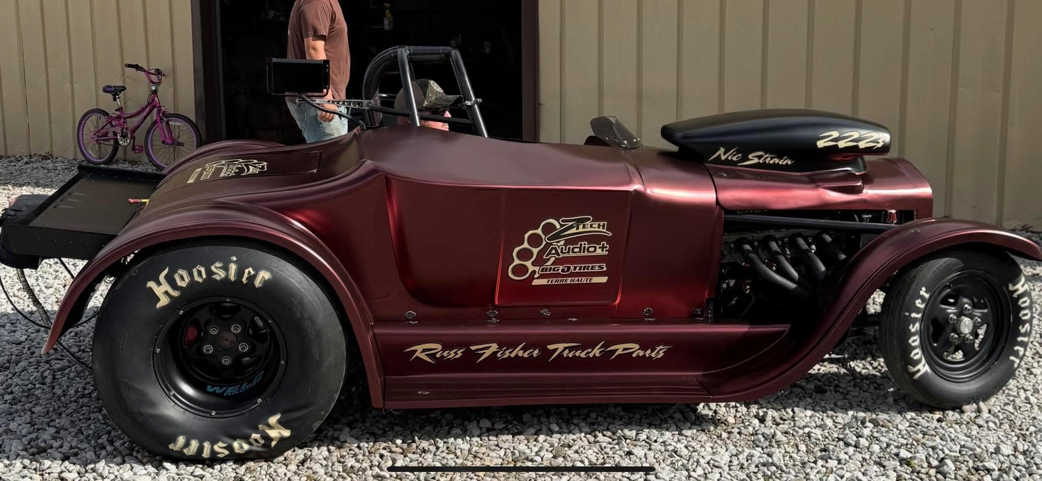 Technician applying car window tint film with squeegee