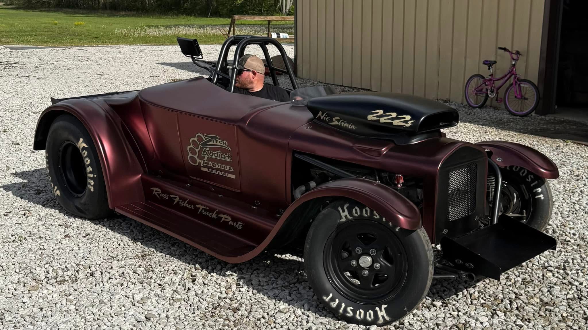 Technician applying car window tint film with squeegee