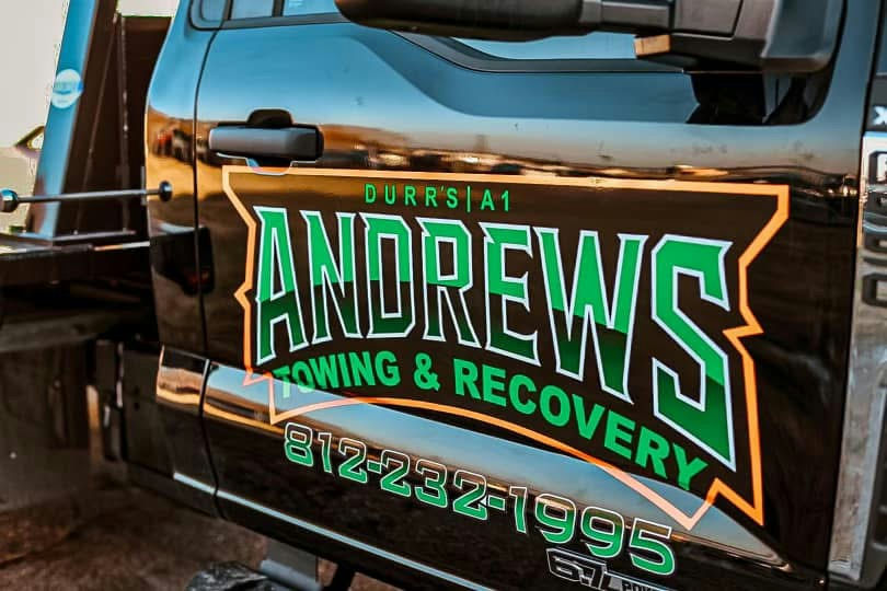 Technician applying car window tint film with squeegee