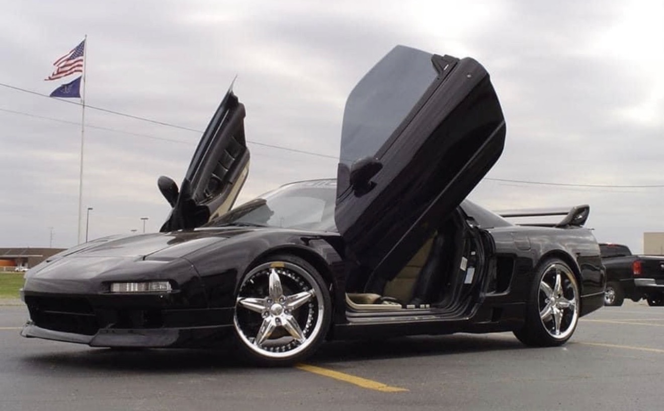 Technician applying car window tint film with squeegee