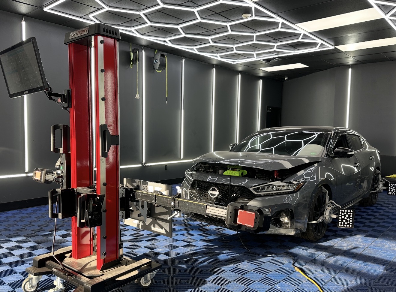 Technician applying car window tint film with squeegee