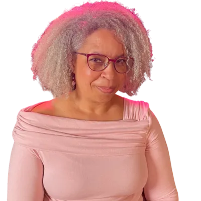 Tanya Spencer smiling with confidence in a soft pink top —representing powerful, intentional planning on calendar page for F🤬ck Being Stuck coaching. 