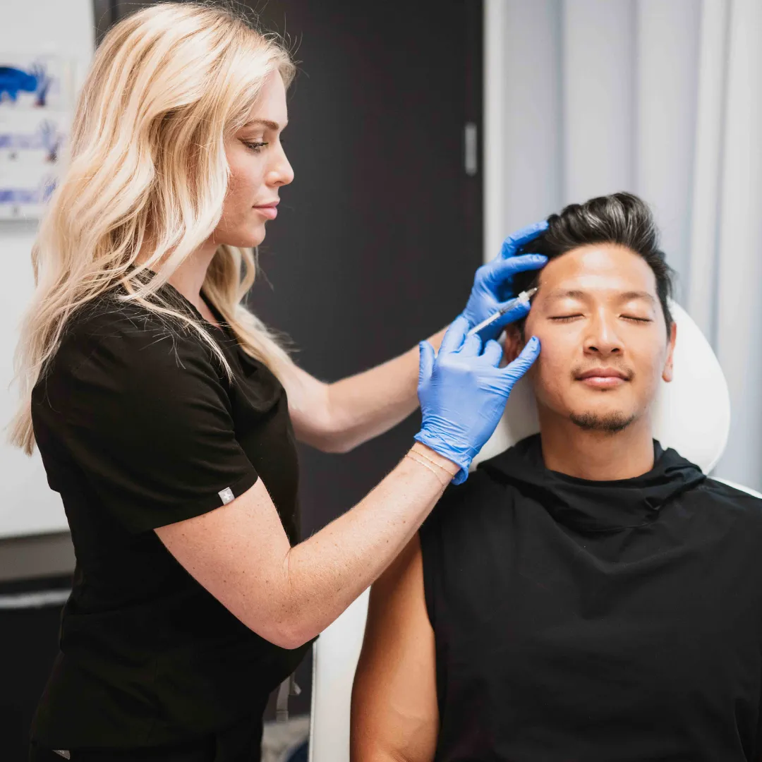 close up of a woman getting injected between her eyes for a botox treatment