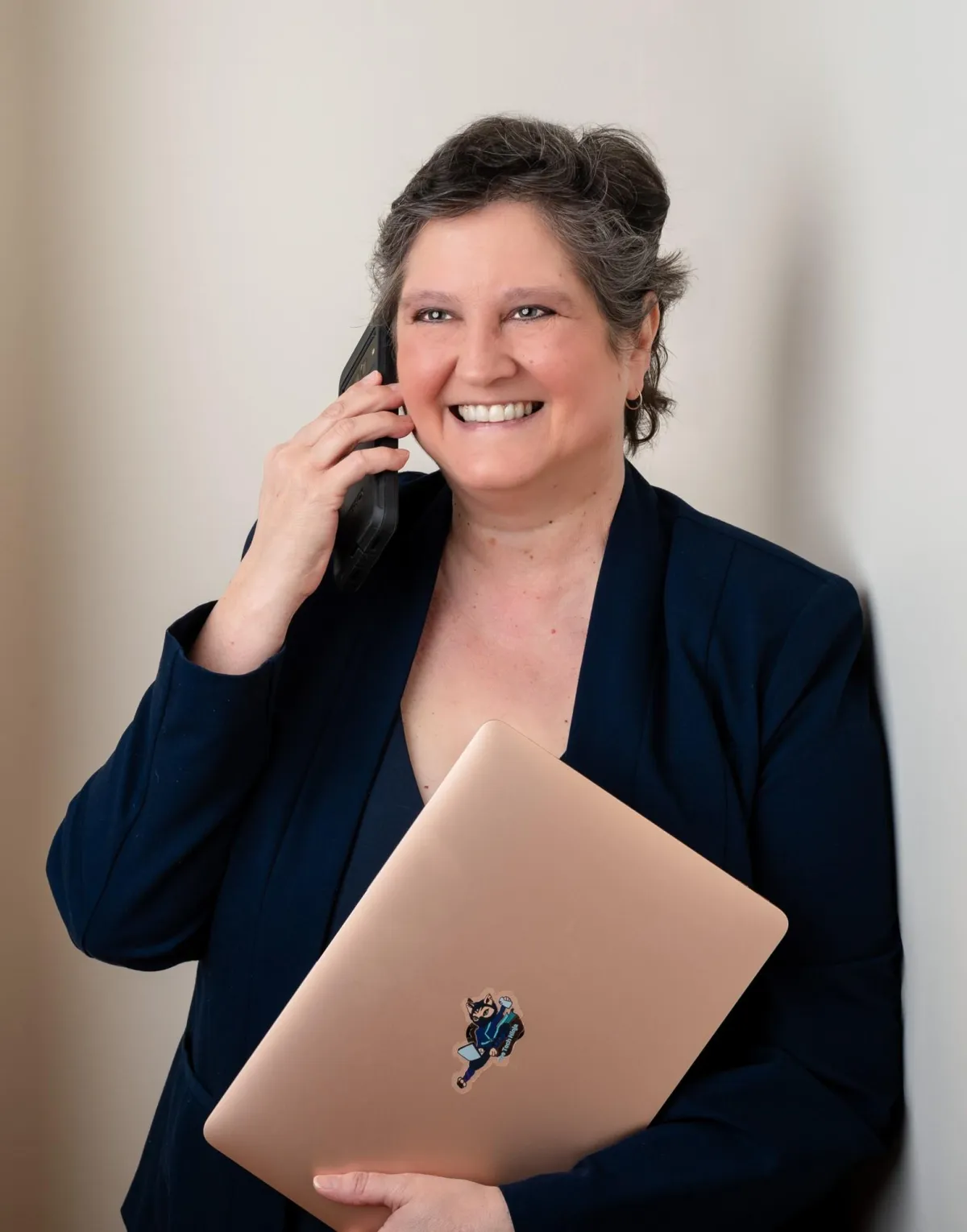 simplify your brand - kat talking on phone holding laptop