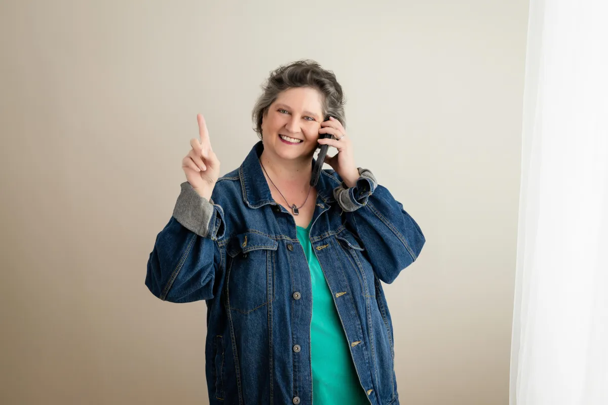 Simplify Your Tech kat denim jacket on phone pointing up