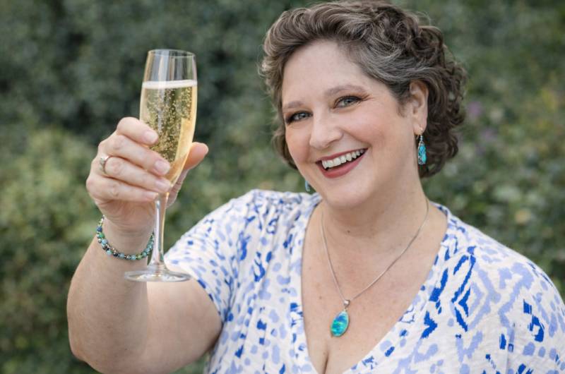 Simplify Your Tech Kat toasting with champagne